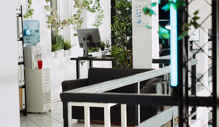 Modern office corridor featuring contemporary interpretation of Arabic geometric patterns in bronze metalwork, with warm lighting and natural stone flooring